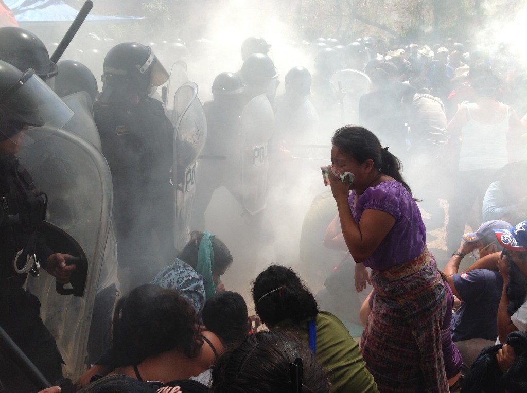 A young indigenous woman is forced to flee from the toxic effects of the tear gas. Photo via Guatemala Human Rights Commission - USA (GHRC)