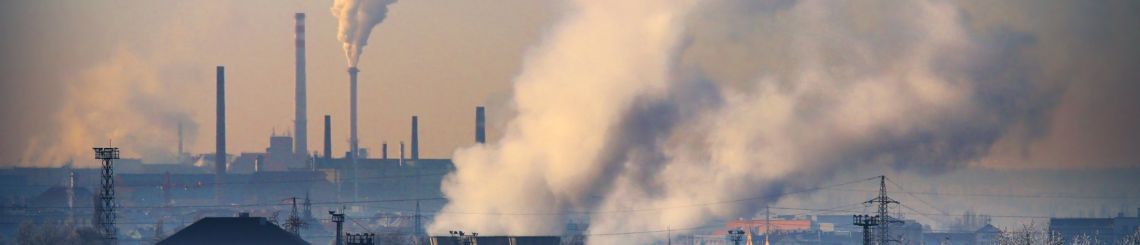 A petrochemical plant with visible smoke rising from its stacks, symbolizing manufacturing processes and pollution.